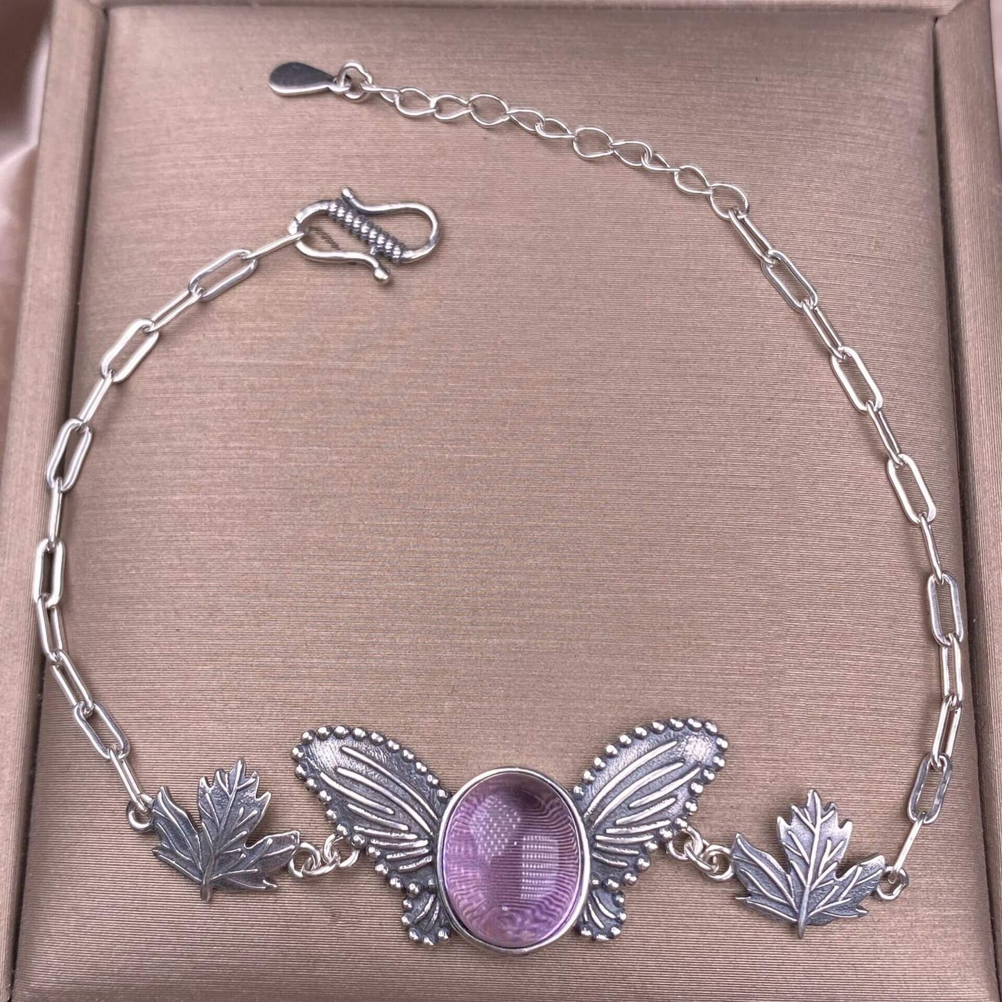 Silver bracelet with leaf and butterfly designs Amethyst